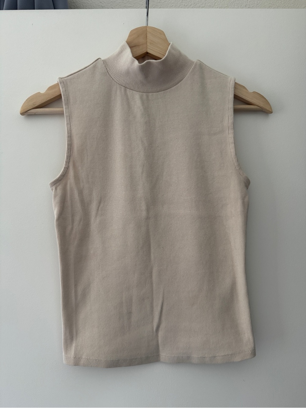 Cream sleeveless mock neck sweater